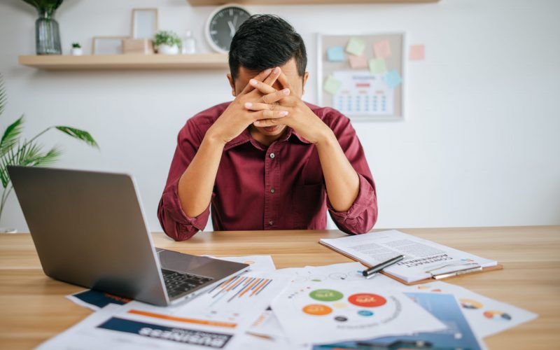 Man working in office and stress Man working with laptop and paperwork with stress